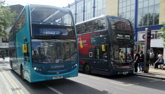 Sapphire Bus 4411 passing National Express
                    WM Bus 6729